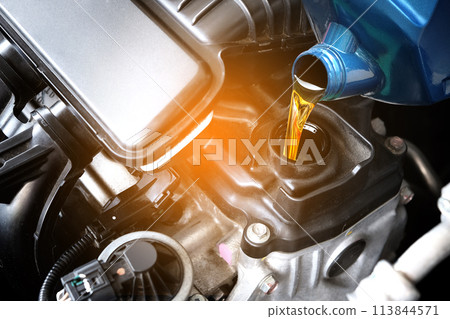 Refueling and pouring oil quality into the engine motor car Transmission and Maintenance Gear .Energy fuel concept. Refueling and pouring oil quality into the engine motor car Transmission and Maintenance Gear .Energy fuel concept. 113844571