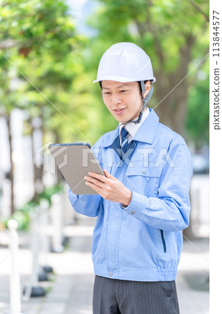 Male portrait in helmet work clothes 113844577
