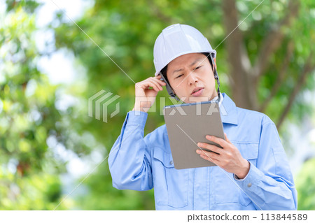 Male portrait in helmet work clothes 113844589