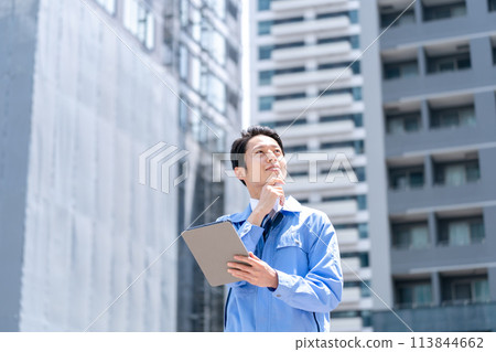 Business man in work clothes at construction site Business man in work clothes at construction site 113844662