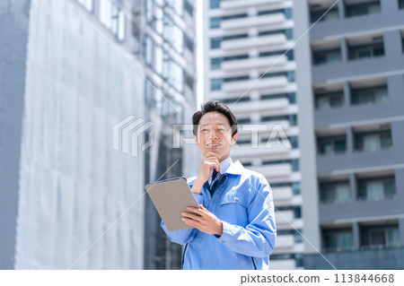 Business man in work clothes at construction site 113844668