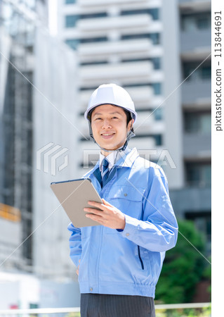 Business man in work clothes at construction site 113844691