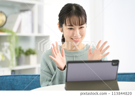 Woman making a video call on a tablet 113844820