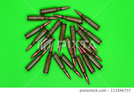 Bullets scattered on a green chroma key top view  113846737