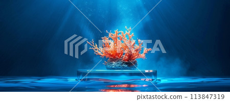 Brilliant orange coral bio-luminescence presented on a sleek platform against a deep blue ocean backdrop 113847319
