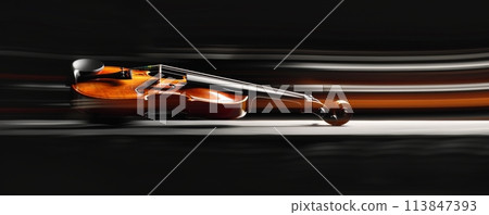 Elegant violin in motion on a black background, showcasing dynamic light trails and artistic blur 113847393