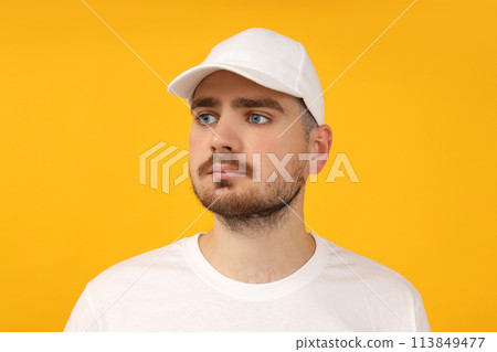 A young guy in a white T-shirt and a white cap 113849477