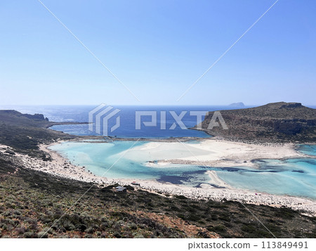 Balos lagoon on Crete island, Greece. Tourists relax and bath in crystal clear water of Balos beach. no effects Balos lagoon on Crete island, Greece. Tourists relax and bath in crystal clear water of Balos beach. no effects 113849491