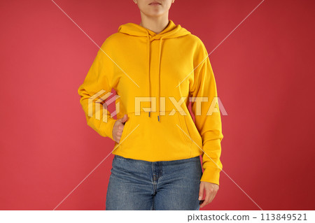 A young woman in a yellow hooded sweatshirt 113849521