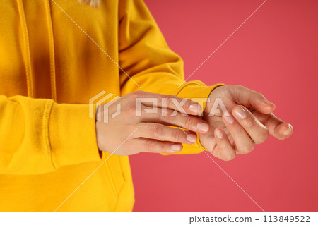 A young woman in a yellow hooded sweatshirt 113849522