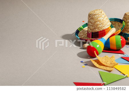 Nachos with sombrero and maracas on a light background 113849582