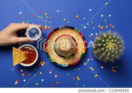 Sombrero with tequila and cactus on a blue background Sombrero with tequila and cactus on a blue background 113849593