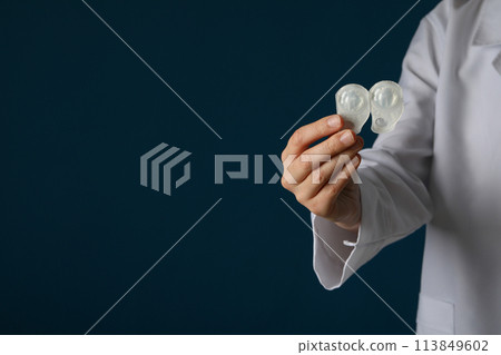 A container for contact lenses in the hand of a doctor A container for contact lenses in the hand of a doctor 113849602
