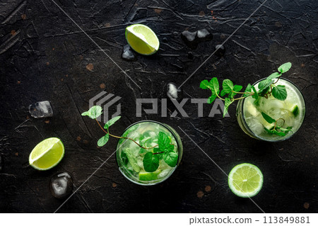 Mojito cocktail. Summer cold drink with lime, fresh mint, and ice. Cool beverage 113849881
