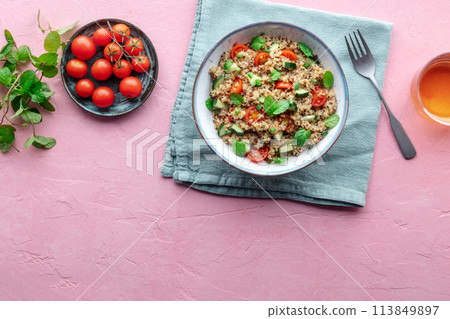 Quinoa tabbouleh salad in a bowl, a healthy dinner with tomatoes and mint Quinoa tabbouleh salad in a bowl, a healthy dinner with tomatoes and mint 113849897