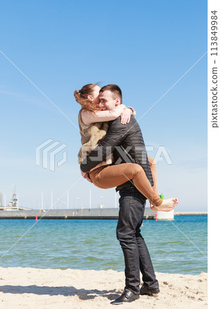 Happy couple having date on beach Happy couple having date on beach 113849984