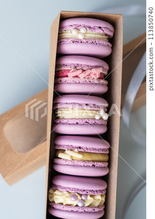 Macaroons with different fillings in a box close-up. Macaroons with different fillings in a box close-up. 113850740