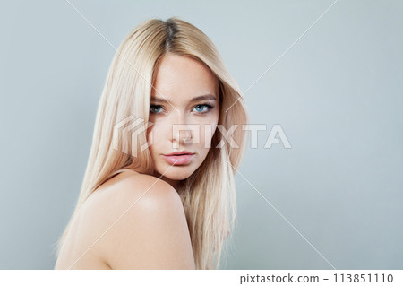 Smiling young blonde lady with fresh clear skin and long smooth straight hairstile  113851110