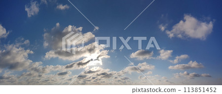 Bright blue sky, sun and white clouds, day weather background 113851452