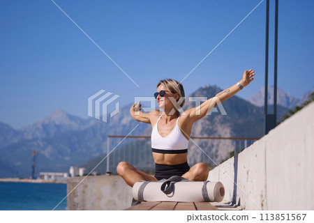 Portrait of caucasian young woman in sporty outfit relaxing meditating feeling zen-like on fitness Portrait of caucasian young woman in sporty outfit relaxing meditating feeling zen-like on fitness 113851567