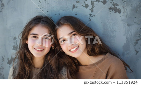 Two smiling young women in knitwear posing together. LGBTQ Pride month. AI generative 113851924