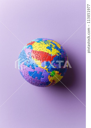 Puzzle globe on a lavender background. Still life photography with copy space. Autistic Pride Day. AI generative 113851977