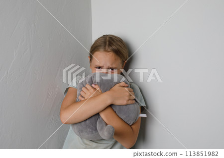 Sad young girl crying and looking at camera at home Sad young girl crying and looking at camera at home 113851982