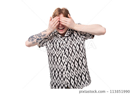 young laughing caucasian ginger man with a tattoo on his arms dressed in a black and white shirt young laughing caucasian ginger man with a tattoo on his arms dressed in a black and white shirt 113851990