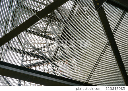 New modern tall metal construction observation tower with steel grid floors, bottom up view New modern tall metal construction observation tower with steel grid floors, bottom up view 113852085