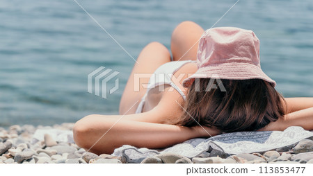 Unrecognizable positive woman in white bikini sunbathing or tanning on seaside beach during summer. happy tourist enjoying sun tan lying on beach chair lounge at luxury resort Unrecognizable positive woman in white bikini sunbathing or tanning on seaside beach during summer. happy tourist enjoying sun tan lying on beach chair lounge at luxury resort 113853477