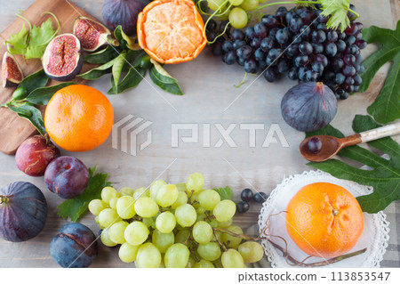 Vitamin food frame on gray wood table background with colorful fruit and berries Vitamin food frame on gray wood table background with colorful fruit and berries 113853547