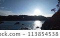 sun setting into the sea 113854538
