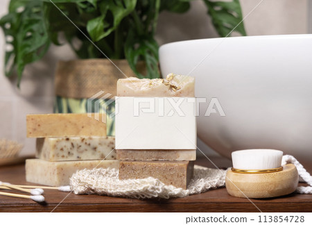 Soap bar with blank label near hygiene products on wood in bathroom close up, mockup Soap bar with blank label near hygiene products on wood in bathroom close up, mockup 113854728