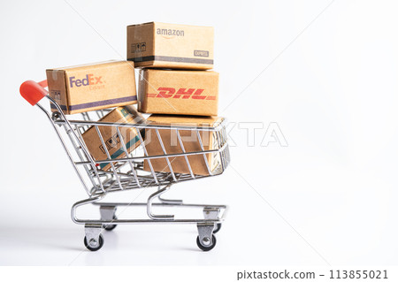 Bangkok, Thailand September 26, 2022 Shopping cart with DHL Amazon and FedEx express packing box, import export online exchange investment business. 113855021