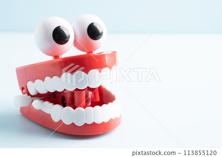 Tooth funny toy denture red color jaw and eye. 113855120