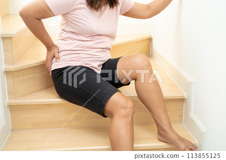 Asian lady fall down the stairs and pain at hip and waist because slippery surfaces. Asian lady fall down the stairs and pain at hip and waist because slippery surfaces. 113855125