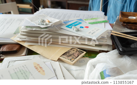 Cash found among piles of documents, secret savings, sorting belongings, messy room Cash found among piles of documents, secret savings, sorting belongings, messy room 113855167