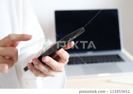 Woman using a smartphone Business image 113855652