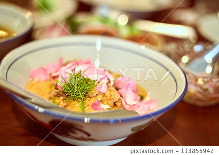 Red curry with grilled pork collar and damask rose Red curry with grilled pork collar and damask rose 113855942