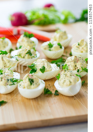 stuffed eggs, deviled eggs on a wooden table 113857463