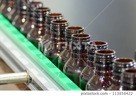 Close up scene the empty drug  bottles  on the conveyor belt for filling process. 113858422