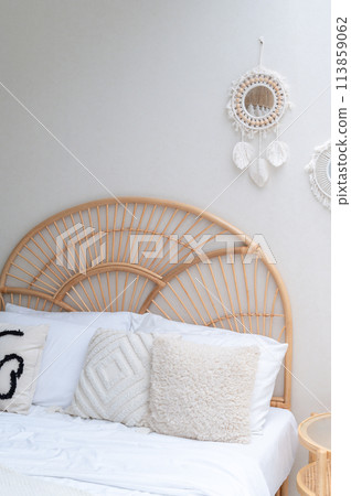 White pillows on wooden weave bed in minimal bedroom interior. Real photo White pillows on wooden weave bed in minimal bedroom interior. Real photo 113859062