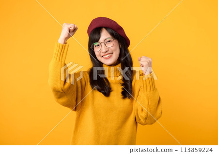 Cool and charismatic. A stylish teenage girl, wearing a red beret and yellow sweater, showcases her vibrant personality against a vibrant yellow background. Cool and charismatic. A stylish teenage girl, wearing a red beret and yellow sweater, showcases her vibrant personality against a vibrant yellow background. 113859224