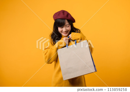 Shopping extravaganza! An enthusiastic woman in a red beret and yellow sweater enjoys discounts against a cheerful yellow backdrop. Shopping extravaganza! An enthusiastic woman in a red beret and yellow sweater enjoys discounts against a cheerful yellow backdrop. 113859258