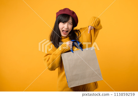 Bagging bargains! A stylish lady in a red beret and yellow sweater celebrates her shopping spree against a vibrant yellow background. Bagging bargains! A stylish lady in a red beret and yellow sweater celebrates her shopping spree against a vibrant yellow background. 113859259