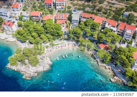 Aerial view of Punta Rata beach with boats and azure sea in Brela, Croatia, Dalmatia, Croatian azure coast Aerial view of Punta Rata beach with boats and azure sea in Brela, Croatia, Dalmatia, Croatian azure coast 113859567