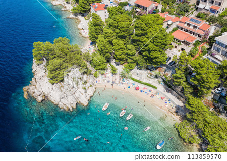 Aerial view of Punta Rata beach with boats and azure sea in Brela, Croatia, Dalmatia, Croatian azure coast Aerial view of Punta Rata beach with boats and azure sea in Brela, Croatia, Dalmatia, Croatian azure coast 113859570