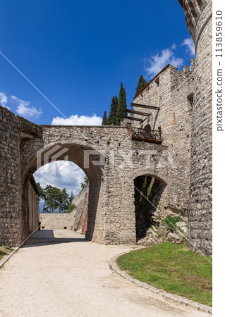 Medieval castle in Brescia with rising bridge archway 113859610
