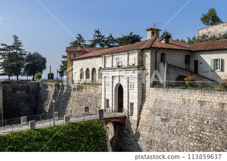 Stone bridge over moat at Brescia castle entrance 113859637