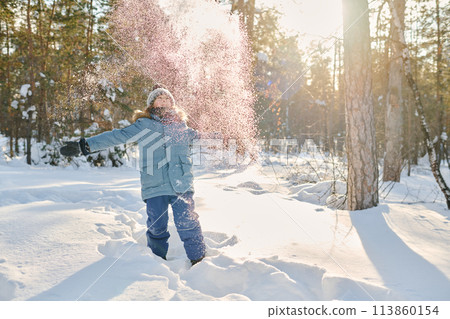 Excited boy throwing snow over his head 113860154